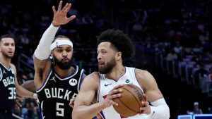 Detroit Pistons guard Cade Cunningham (2) drives against Milwaukee Bucks guard Gary Trent Jr. (5) during the first half of an NBA basketball game Wednesday, April 8, 2026, in Detroit. (Duane Burleson/AP)
