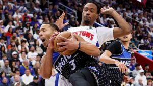 Orlando Magic guard Desmond Bane (3) grabs a rebound in front of Detroit Pistons forward Ronald Holland II, top right, during the first half in Game 1 of a first-round NBA basketball playoffs series Sunday, April 19, 2026, in Detroit. (Duane Burleson/AP)