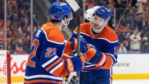 Edmonton Oilers' Matt Savoie (22) and Zach Hyman (18) celebrate a goal against the Chicago Blackhawks during second period NHL action, in Edmonton on Thursday April 2, 2026. (Jason Franson/CP)