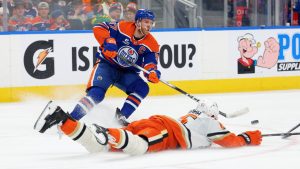 Anaheim Ducks’ Jacob Trouba (65) slides in front of Edmonton Oilers’ Connor McDavid (97) during second period NHL action, in Edmonton on Saturday March 28, 2026. (James Maclennan/CP)