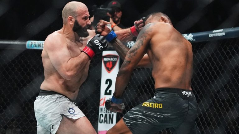 Russia's Azamat Murzakanov, left, punches Brazil's Brendson Ribeiro during the first round of a light heavyweight bout at the UFC 316 mixed martial arts event Saturday, June 7, 2025 in Newark, N.J. (AP Photo/Frank Franklin II)