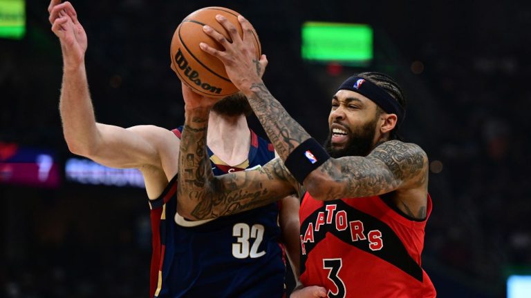 Toronto Raptors forward Brandon Ingram drives on Cleveland Cavaliers forward Dean Wade during the first half in Game 1 of a first-round NBA playoffs basketball series, Saturday, April 18, 2026, In Cleveland. (David Dermer/AP)