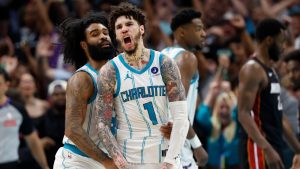 Charlotte Hornets guard LaMelo Ball (1) celebrates with guard Coby White after scoring against the Miami Heat during the second half of an NBA play-in tournament basketball game in Charlotte, N.C., Tuesday, April 14, 2026. (AP Photo/Nell Redmond)