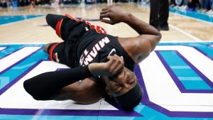 Miami Heat center Bam Adebayo (13) lies on the court during the first half of an NBA play-in tournament basketball game against the Charlotte Hornets in Charlotte, N.C., Tuesday, April 14, 2026. (AP Photo/Nell Redmond)