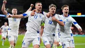 Bosnia and Herzegovina's Edin Dzeko, centre left, celebrates with team-mates after scoring their side's first goal during the World Cup playoff semifinal soccer match between Wales and Bosnia and Herzegovina in Cardiff, Wales, Thursday, March 26, 2026. (Nick Potts/PA via AP)