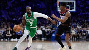 Boston Celtics' Jaylen Brown, left, tries to get past Philadelphia 76ers' VJ Edgecombe during the first half of Game 4 in a first-round NBA basketball playoffs series Sunday, April 26, 2026, in Philadelphia. (Matt Slocum/AP)