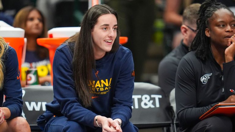 Indiana Fever guard Caitlin Clark looks on from the bench during the first half of a WNBA basketball game against the Dallas Wings Friday, Aug. 1, 2025, in Dallas. (Julio Cortez/AP)