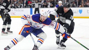 Edmonton Oilers centre Connor McDavid moves the puck against Los Angeles Kings defenceman Brian Dumoulin during the third period of an NHL game Thursday, Feb. 26, 2026 in Los Angeles. (AP/Ryan Sun)