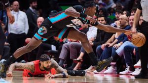 Memphis Grizzlies' Olivier-Maxence Prosper (18) leaps past Toronto Raptors' Brandon Ingram (3) as he vies for control of the ball during second half NBA action in Toronto, on Sunday, Nov. 2, 2025. (Sammy Kogan/CP)