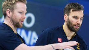 Sweden's Christoffer Sundgren and Niklas Edin speak, during the men's curling round robin session against Norway at the 2026 Winter Olympics, in Cortina d'Ampezzo, Italy, Tuesday, Feb. 17, 2026. (AP Photo/Fatima Shbair)