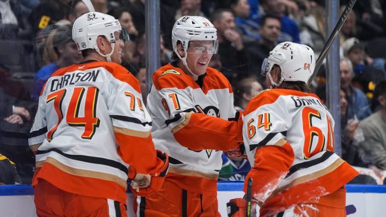 Anaheim Ducks' Mikael Granlund, right, celebrates his goal with teammates John Carlson, left, and Leo Carlsson during the second period of an NHL hockey game against the Vancouver Canucks, in Vancouver, on Tuesday, March 24, 2026. THE CANADIAN PRESS/Darryl Dyck