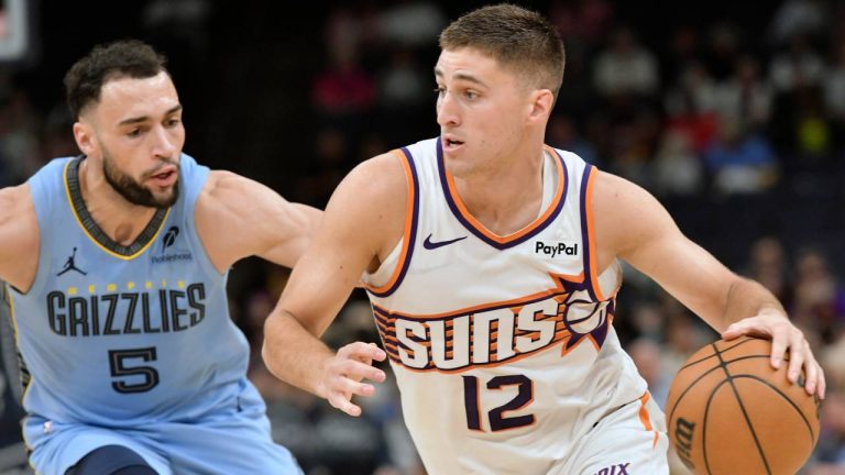 Phoenix Suns guard Collin Gillespie (12) handles the ball against Memphis Grizzlies forward Tyler Burton (5) in the second half of an NBA basketball game Monday, March 30, 2026, in Memphis, Tenn. (Brandon Dill/AP)