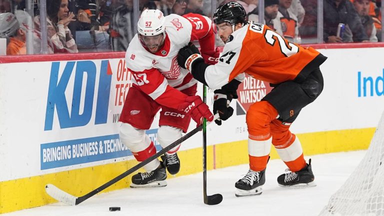 Philadelphia Flyers' Noah Cates, right, and Detroit Red Wings' David Perron, left, battle for the puck during the first period of an NHL hockey game, Thursday, April 2, 2026, in Philadelphia. (Matt Rourke/AP)