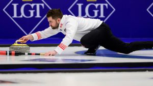 Canada's Matt Dunstone delivers a stone during a quarterfinal match against Italy at the curling world championships, Friday, April 3, 2026, in Ogden, Utah. (AP Photo/Tyler Tate)
