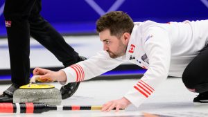 Canada's Matt Dunstone delivers the rock during a gold medal match against Sweden at the curling world championships, Saturday, April 4, 2026, in Ogden, Utah. (AP Photo/Tyler Tate)