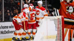 Calgary Flames center Ryan Strome, third from left, is greeted by teammates after scoring during the second period of an NHL hockey game against the Anaheim Ducks, Saturday, April 4, 2026, in Anaheim, Calif. (AP Photo/William Liang)