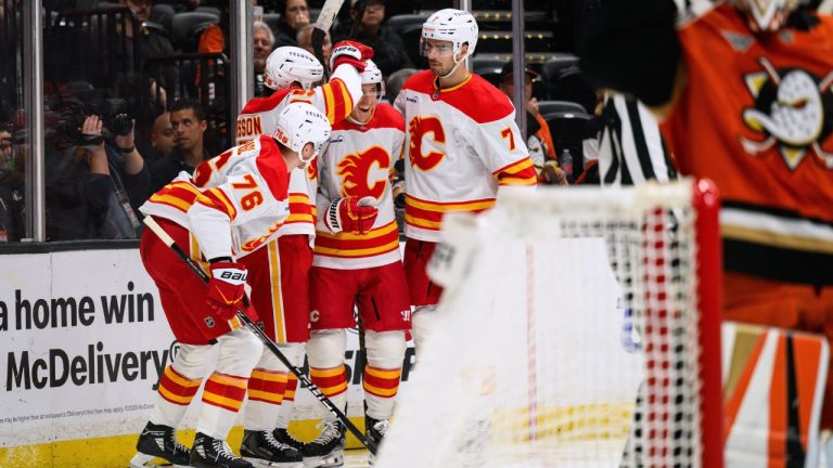 Calgary Flames center Ryan Strome, third from left, is greeted by teammates after scoring during the second period of an NHL hockey game against the Anaheim Ducks, Saturday, April 4, 2026, in Anaheim, Calif. (AP Photo/William Liang)