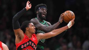 Toronto Raptors forward Collin Murray-Boyles, left, and Boston Celtics center Neemias Queta vie for control of the ball in the first half of an NBA basketball game, Sunday, April 5, 2026, in Boston. (Steven Senne/AP)