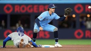 Los Angeles Dodgers two-way player Shohei Ohtani (17) gets back to the base as Toronto Blue Jays third baseman Ernie Clement (22) tries for for the tag during first inning Inter League MLB baseball action in Toronto on Wednesday, April 8, 2026. (Nathan Denette/CP)