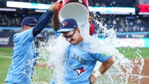 Toronto Blue Jays' Davis Schneider gets doused after defeating the Los Angeles Dodgers in MLB baseball action in Toronto on Wednesday, April 8, 2026. (Nathan Denette/CP)