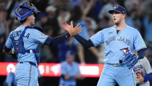 Toronto Blue Jays catcher Brandon Valenzuela, left, celebrates with pitcher Jeff Hoffman after defeating the Los Angeles Dodgers in MLB baseball action in Toronto on Wednesday, April 8, 2026. (Nathan Denette/CP)
