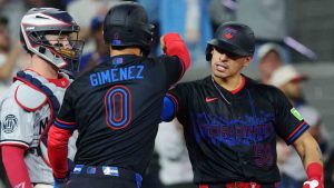 Toronto Blue Jays' Brandon Valenzuela (right) celebrates his two-run home run with Andres Gimenez (0) in front of Minnesota Twins catcher Ryan Jeffers (27) during fourth inning MLB baseball action in Toronto on Friday, April 10, 2026. (Chris Young/CP)