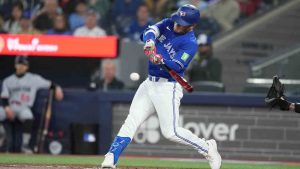 Toronto Blue Jays center fielder Daulton Varsho (5) hits an RBI single off Minnesota Twins pitcher Taj Bradley during first inning American League MLB baseball action in Toronto on Sunday, April 12, 2026. (Nathan Denette/CP)