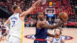 LA Clippers forward Kawhi Leonard, center, shoots as Golden State Warriors center Kristaps Porzingis defends during the first half of an NBA play-in tournament basketball game Wednesday, April 15, 2026, in Inglewood, Calif. (Mark J. Terrill/AP)