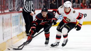 Carolina Hurricanes' Sebastian Aho (20) battles with Ottawa Senators' Tim Stützle (18) for the puck during the second period of Game 2 of an NHL hockey Stanley Cup first-round playoff series in Raleigh, N.C., Monday, April 20, 2026. (AP Photo/Karl DeBlaker)