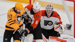 Pittsburgh Penguins' Bryan Rust (17) cannot get his stick on the puck while defended by Philadelphia Flyers' Travis Sanheim (6) in front of Flyers goaltender Dan Vladar, right, during the third period of Game 2 in the first round of the NHL Stanley Cup playoffs in Pittsburgh, Monday, April 20, 2026. (Gene J. Puskar/AP)