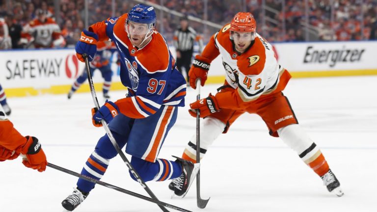 Anaheim Ducks' Tim Washe (42) pursues Edmonton Oilers' Connor McDavid (97) during second period NHL playoff action in Edmonton on Monday, April 20, 2026. THE CANADIAN PRESS/Codie McLachlan