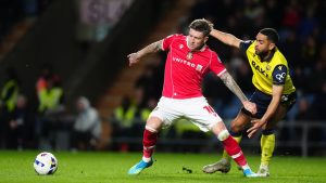 Wrexham's Josh Windass, left, and Oxford United's Brodie Spencer battle for the ball during the EFL Championship soccer match between Oxford United and Wrexham, Tuesday, April 28, 2026, in Oxford, England. (David Davies/PA via AP)