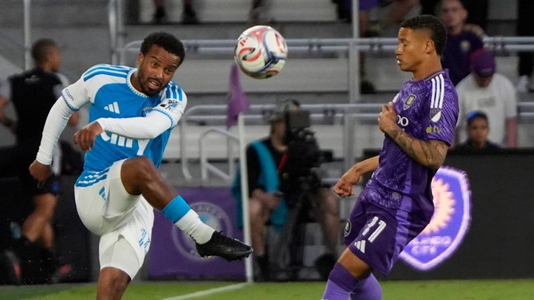 Charlotte FC defender Nathan Byrne, left, passes the ball over Orlando City SC midfielder Tiago during the first half of an MLS soccer match, Wednesday, April 22, 2026, in Orlando, Fla. (John Raoux/AP)