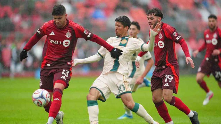 Toronto FC's Benjamín Kuscevic (13) battles for the ball with Atlanta United's Cayman Togashi (30) during first half MLS soccer action in Toronto on Saturday, April 25, 2026. (Frank Gunn/CP)