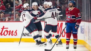 Columbus Blue Jackets' Mason Marchment (17), Danton Heinen (43), Erik Gudbranson (44) and Charlie Coyle (3) celebrate a goal while Montreal Canadiens' Alex Newhook (15) looks on, during first period NHL hockey action in Montreal on Saturday, April 11, 2026. (Christopher Katsarov/CP)