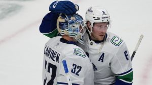 Vancouver Canucks right wing Brock Boeser, right, congratulates goaltender Kevin Lankinen after defeating the Colorado Avalanche in an NHL hockey game Wednesday, April 1, 2026, in Denver. (David Zalubowski/AP)