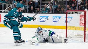 Vancouver Canucks goaltender Kevin Lankinen, right, blocks a shot by San Jose Sharks centre Macklin Celebrini (71) during the first period of an NHL hockey game in San Jose, Calif., Saturday, April 11, 2026. (Tony Avelar/AP)