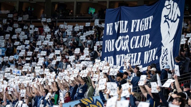 Vancouver Whitecaps fans hold signs before the first half of an MLS soccer match against the Colorado Rapids in Vancouver, on Saturday, April 25, 2026. (Ethan Cairns/CP)