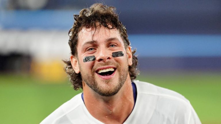 Toronto Blue Jays third baseman Ernie Clement (22) smiles after getting soaked by teammates after hitting a game-winning RBI single during eleventh inning MLB baseball action against the Athletics, in Toronto on Saturday, March 28, 2026. (Frank Gunn/CP)