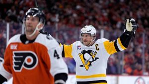 Pittsburgh Penguins' Sidney Crosby, right, reacts behind Philadelphia Flyers' Luke Glendening after scoring during the first period of Game 4 in the first round of the NHL Stanley Cup hockey playoff series Saturday, April 25, 2026, in Philadelphia. (Matt Slocum/AP)