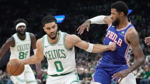 Boston Celtics forward Jayson Tatum (0) drives against Philadelphia 76ers forward Paul George, right, during the first half in Game 1 of a first-round NBA playoffs basketball game, Sunday, April 19, 2026, in Boston. (Robert F. Bukaty/AP)