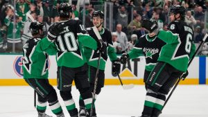 Dallas Stars' Colin Blackwell (15), Oskar Bäck (10), Wyatt Johnston, center rear, and Lian Bichsel (6) celebrate after Johnston scored against the Minnesota Wild in the first period of Game 2 of a first-round NHL Stanley Cup playoffs hockey series Monday, April 20, 2026, in Dallas. (Tony Gutierrez/AP)