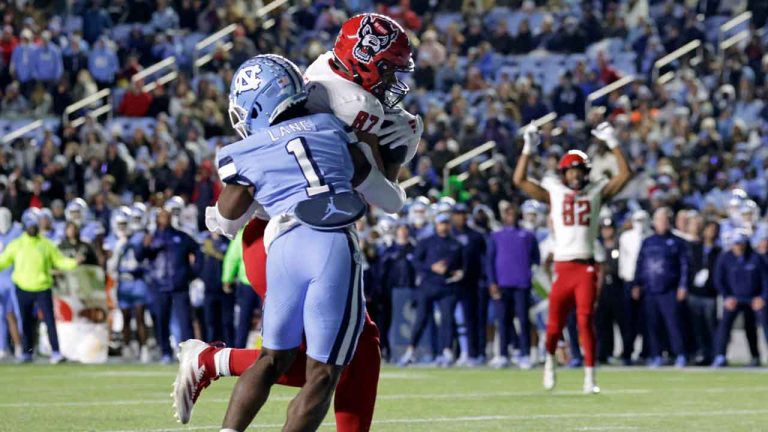 North Carolina State tight end Dante Daniels (87) hauls in a touchdown pass against North Carolina defensive back Antavious Lane (1) while North Carolina State wide receiver Keenan Jackson (82) reacts during the second half of an NCAA college football game. (Chris Seward/AP)