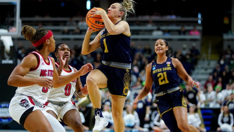 Notre Dame guard Dara Mabrey (1) puts up a shot against North Carolina State guard Kai Crutchfield, left, and guard Diamond Johnson (0) during the second quarter of a college basketball game in the Sweet Sixteen round of the NCAA women's tournament, Saturday, March 26, 2022, in Bridgeport, Conn. (AP Photo/Frank Franklin II)