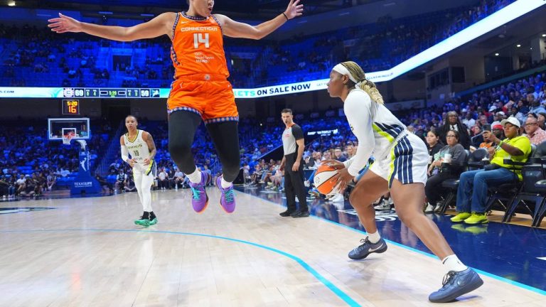 Connecticut Sun guard Bria Hartley (14) jumps to defend the shot by Dallas Wings forward Diamond Miller, right, during the second half of a WNBA basketball game in Arlington, Texas, Wednesday, Aug. 27, 2025. (LM Otero/AP)