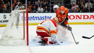 Anaheim Ducks right wing Beckett Sennecke (45) looks to shoot the puck past Calgary Flames goaltender Devin Cooley (1) during the first period of an NHL hockey game Saturday, April 4, 2026, in Anaheim, Calif. (William Liang/AP)