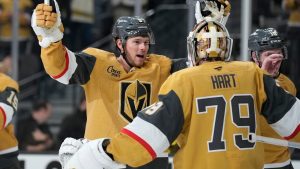 Vegas Golden Knights defenceman Jeremy Lauzon, left, celebrates with Vegas Golden Knights goaltender Carter Hart (79) after defeating the Utah Mammoth in Game 1 of a first-round NHL hockey Stanley Cup playoff series Sunday, April 19, 2026, in Las Vegas. (AP Photo/John Locher)