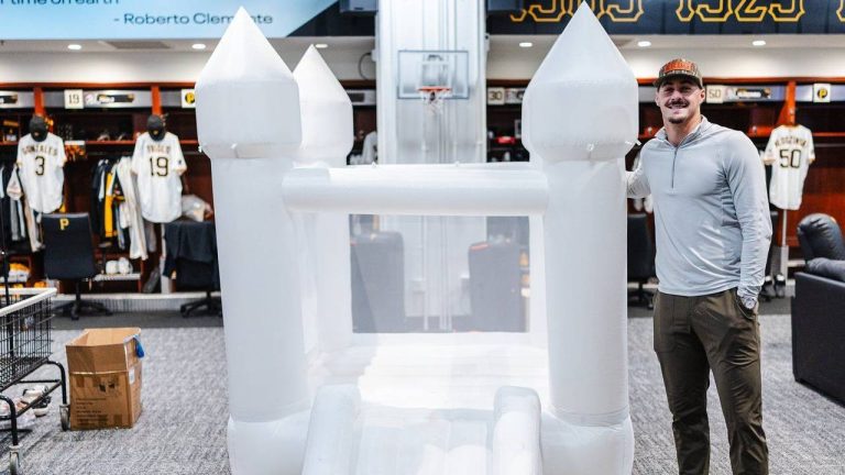 Pittsburgh Pirates rookie Konnor Griffin poses for a photo standing next to a bounce house in the clubhouse that was rented by teammate Paul Skenes to celebrate Griffin's 20th birthday on Monday, April 27, 2026, at PNC Park in Pittsburgh. (Harrison Barden/Pittsburgh Pirates via AP)
