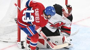New Jersey Devils goaltender Jacob Markstrom stops Montreal Canadiens' Cole Caufield (13) during third period NHL hockey action in Montreal, Sunday, April 5, 2026. (Graham Hughes/CP)