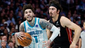 Charlotte Hornets guard LaMelo Ball (1) drives to the basket against Miami Heat forward Jaime Jaquez Jr. during the first half of an NBA play-in tournament basketball game in Charlotte, N.C., Tuesday, April 14, 2026. (Nell Redmond/AP)